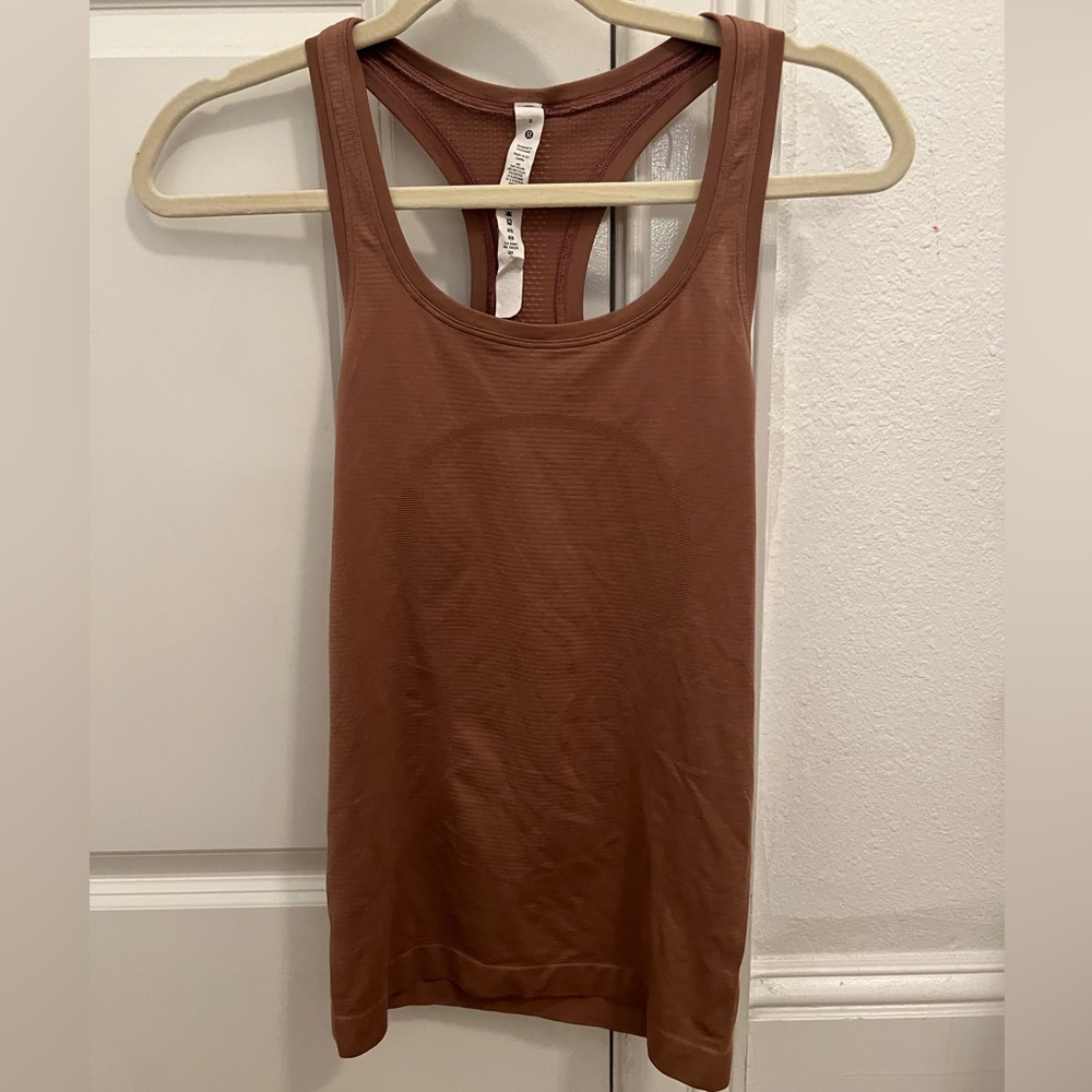 lululemon swiftly tank in a light brown color, the tank top is lighter in person